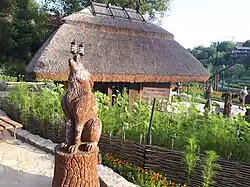 A photograph of a wooden sculpture of werewolf