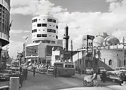 The Mirjan Mosque and the Abboud Building on the street by Latif al-Ani.