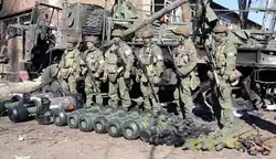 Russian soldiers wearing EMR posing with captured weapons, 2023