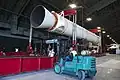 A forklift is seen working a stand holding an SRMU rocket.