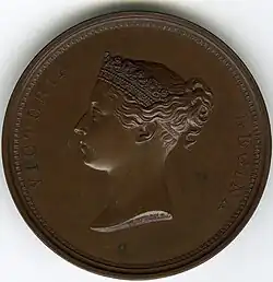 Bronze medal with a portrait of a woman facing left