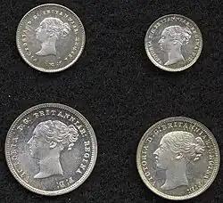 Silver coins with a woman's head facing left