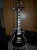 A Gibson Les Paul Custom guitar with an ebony fretboard