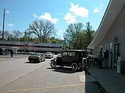 Cars queuing before a South Shore Line train at a railroad crossing