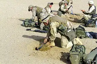 US Marines digging "fighting holes" near the Iraqi border, 2003.