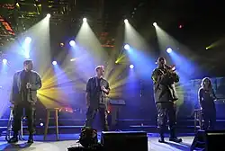 4TROOPS performing aboard the USS Intrepid in New York City during a taping of a PBS television special in 2010