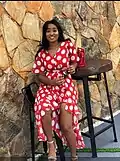 Woman in red dress with white polka dots