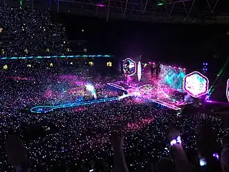 Stage lights being activated in a darkened stadium