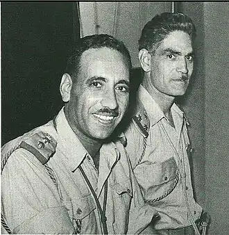 Two Iraqi officers in uniform in profile.