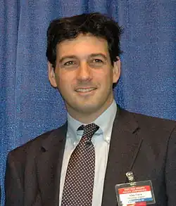 Alan Gura waist up in a suit