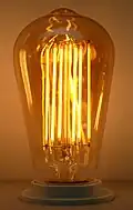 A LED filament bulb with an amber-colored glass shell and many filaments for better visual effects
