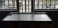 Post office: a writing desk in front of a design protruding window frame