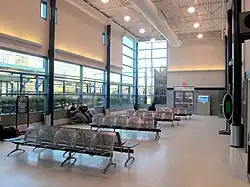 A waiting room in a glass-walled station
