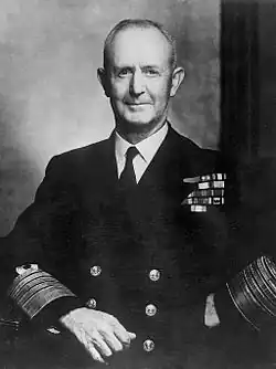 A middle-aged man posing in naval uniform.
