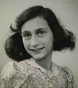 A black and white photograph of a thirteen year-old girl slightly smiling and looking directly at the camera with her head tilted slightly to the viewer's left