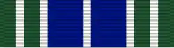 Width-44 ribbon with two width-9 ultramarine blue stripes surrounded by two pairs of two width-4 green stripes; all these stripes are separated by width-2 white borders