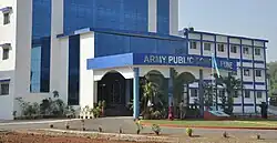 exterior of the school building which is blue in colour