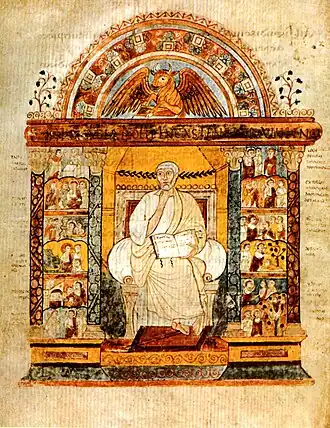 An illuminated manuscript illustration of a central seated figure holding an open book. He is flanked by two colonnades filled with small scenes. Over the central figure is an arch which surmounts a winged bull.