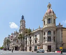 a large building with a central tower and corner towers with domed tops that are tiled
