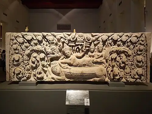 Lintel depicting the Hindu god Nārāyaṇa sleeping upon the serpent Śeṣa in the middle of the Milky Ocean; around 12th century; obtained from the Ku Suan Taeng Temple (Ban Mai Chaiyaphot District, Buri Ram Province); Bangkok National Museum