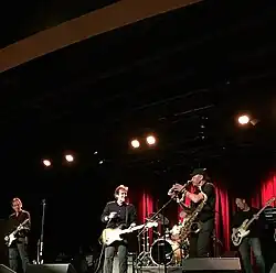 Members of the Beaver Brown Band perform at an indoor concert