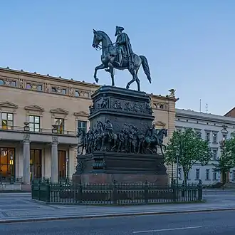 Monument with mounted rider at the peak, and tiers of statues.