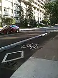 Cycle track with concrete barriers in downtown Ottawa, Ontario, Canada on Laurier Avenue in 2011.