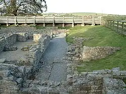 The ruins of a building. The remains of stone walls up to about 1-foot (0.30 m) are all that remains.