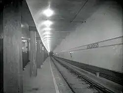 A black-and-white photo of an underground streetcar station