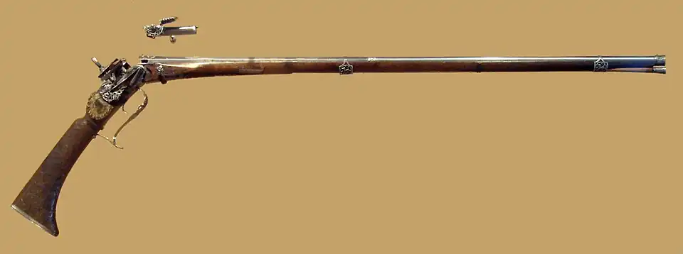 Breech-loading firearm that belonged to Philip V of Spain, made by A. Tienza, Madrid circa 1715. It came with a ready-to-load reusable cartridge. This is a miquelet system.
