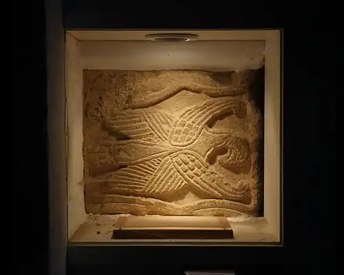 Anglo-Saxon relief just inside the Norman south door, representing the eagle of St John the Evangelist. It was an arm of a cross and may be 9th-century.