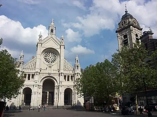 The current church's façade (left) and original church's tower (right)