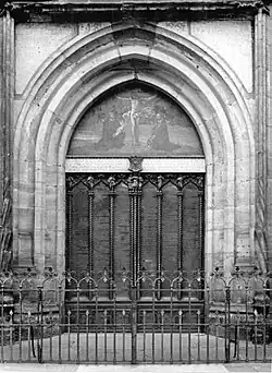 Black-and-white photograph of a church door framed by a Gothic portal
