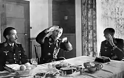 Photo of three German officers sitting at the table