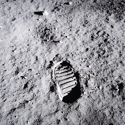 A bootprint in gray dust.