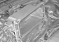 The "butter dish" covers seal the leak paths through (and around) Powered Bolts and Powered Bolt Nuts. When used on the ACBM's bolt, the actuator and upper housing are removed and a spline lock is installed inside the dish to keep the bolt from gradually backing out under cyclic loads.[6] [4]