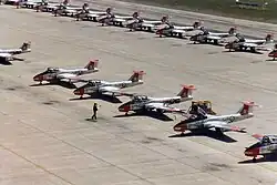 CT-114 Tutors belonging to 2 Canadian Forces Flying Training School parked on the ramp at CFB Moose Jaw, 1982