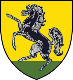 a prancing horse on a yellow background with green grass at the bottom
