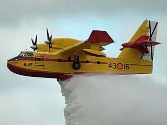 Canadair CL-215 extinguishing fire, with a bright yellow livery