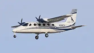 A white and blue twin-engine propeller aircraft