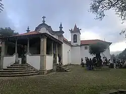 A white church, with people standing outside