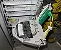 Inside one of the trays with fiber splices inside the tray and connectors folded out