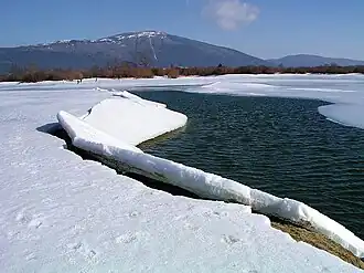 Lake Cerknica in winter, with the summit of Mount Slivnica in the background