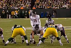 A photo of two football teams lined up against each other during a game