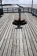 The pay to use telescope showing the name plates on the floorboards.