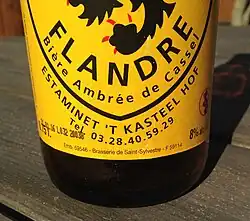 Close up of a bottle of Kassels Bier, the "House Beer" of the Estaminet 'T Kasteel Hof, in Cassel, Nord, France, showing brewery (Brasserie de Saint-Sylvestre).