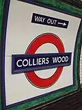 Station roundel with a direction of the way out