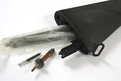 Storage compartment inside a buttstock with opened trapdoor