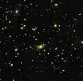 Abell 1300 acts like a lens, bending the very fabric of space around it.[29]