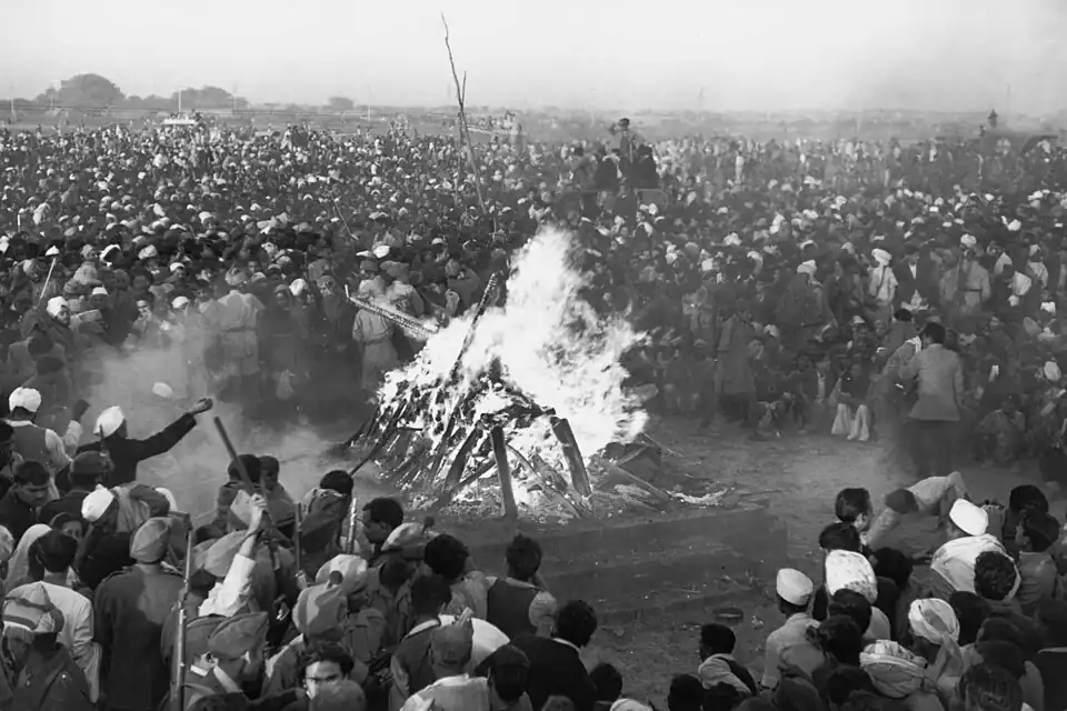 Cremation of Mahatma Gandhi at Rajghat, 31 January 1948. It was attended by Jawaharlal Nehru, Lord and Lady Mountbatten, Maulana Azad, Rajkumari Amrit Kaur, Sarojini Naidu and other national leaders. His son Devdas Gandhi lit the pyre.[111]